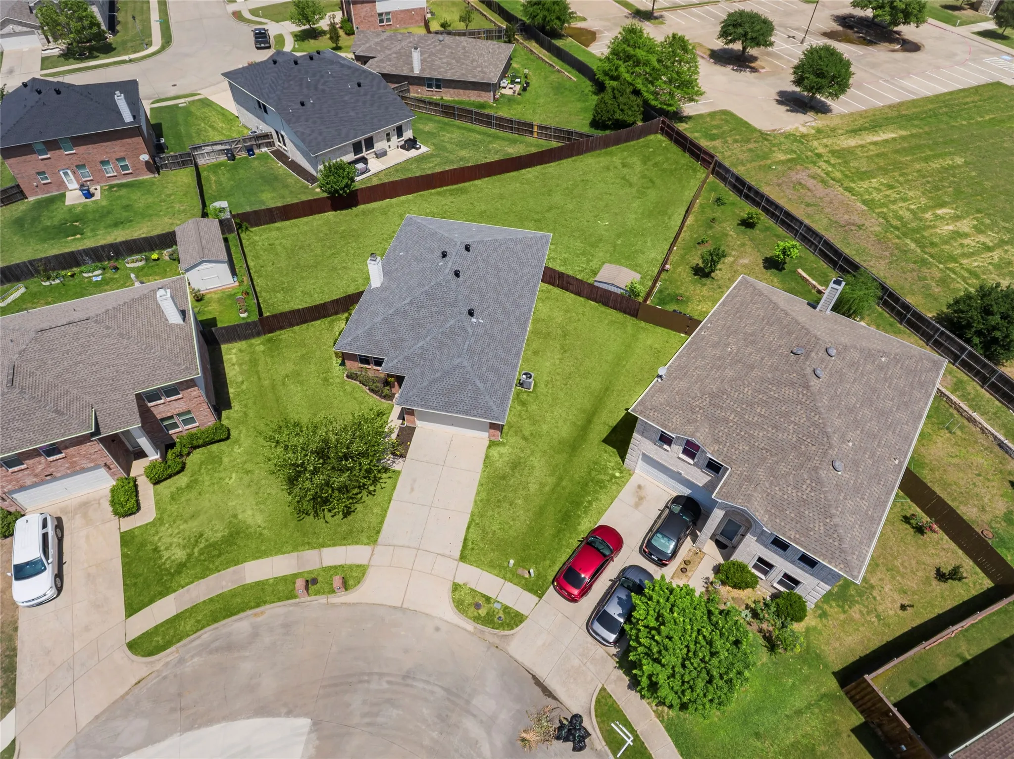 Expansive backyard featuring an established privacy fencing, and a dedicated storage shed
