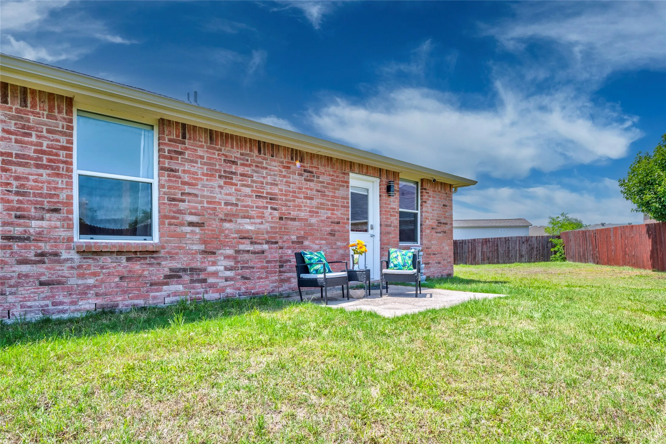 Brick exterior with a backyard patio....