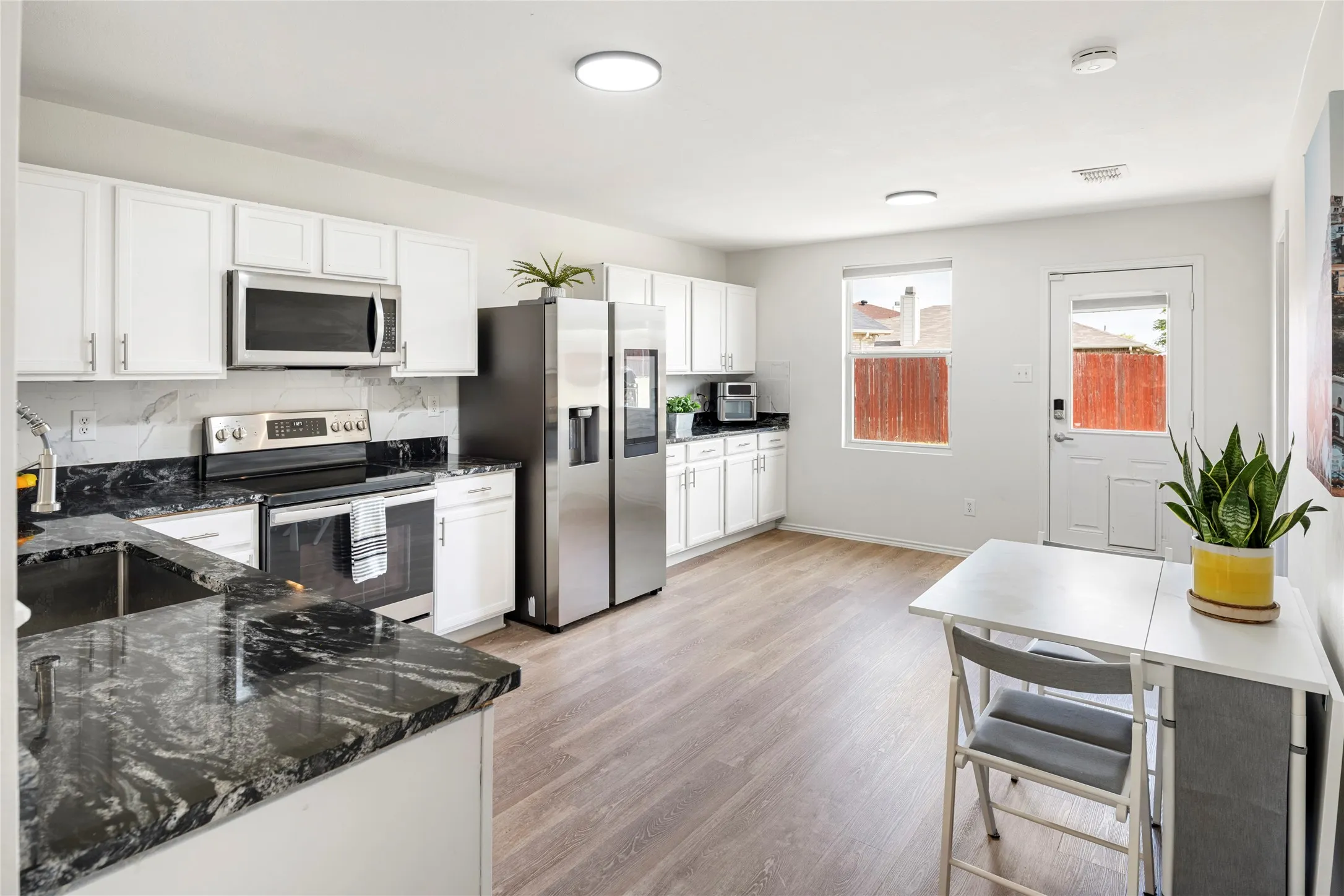 What a lovely, bright kitchen with lots of room for a larger table with chairs for an eat in kitchen.....