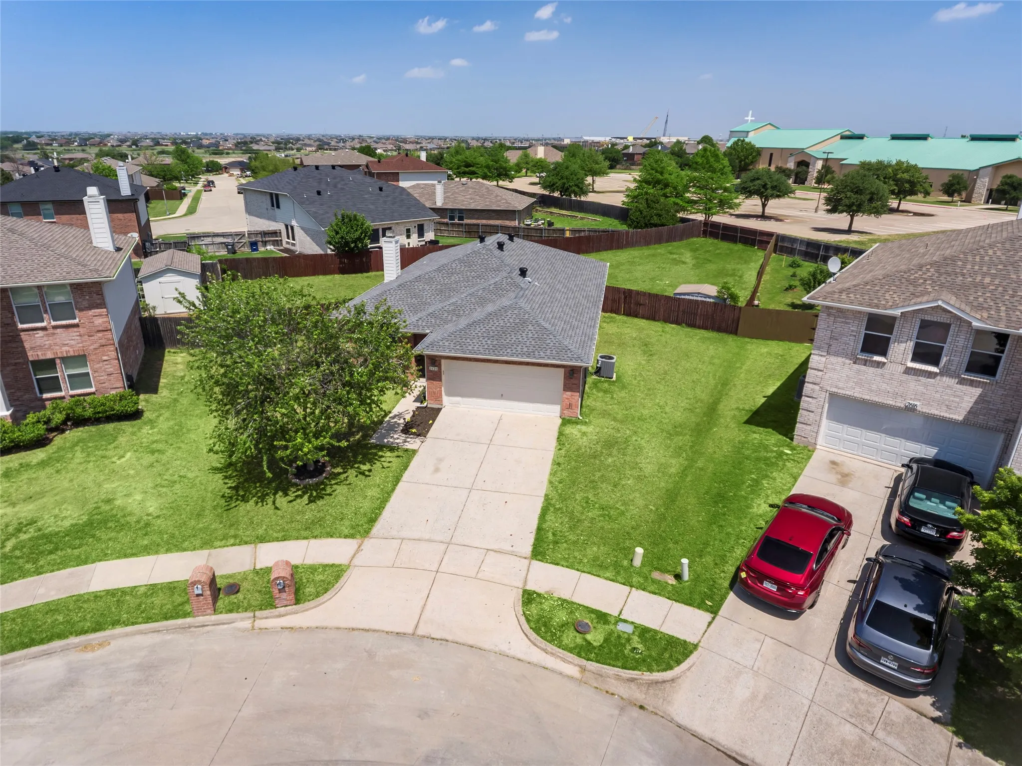 Single-story residence featuring a brick facade, attached garage, and a concrete driveway on a corner lot....