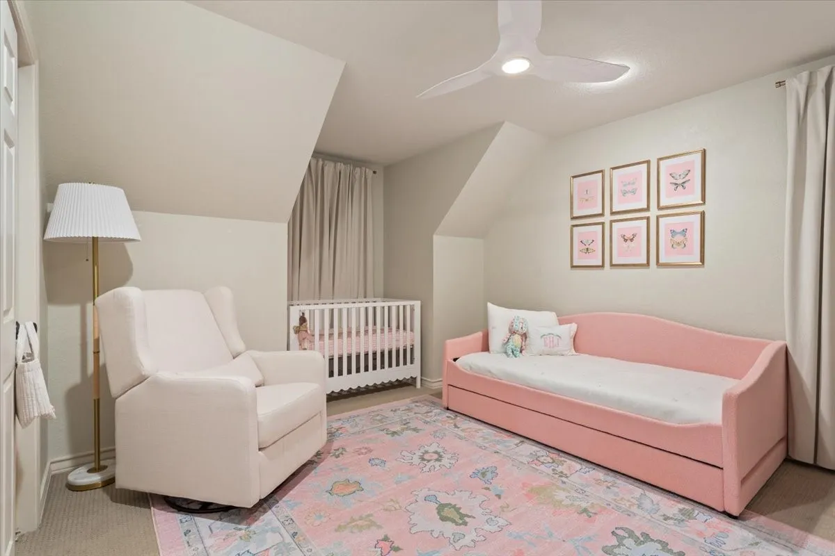 Upstairs room featuring sloped ceilings, light-toned walls, and carpeted flooring