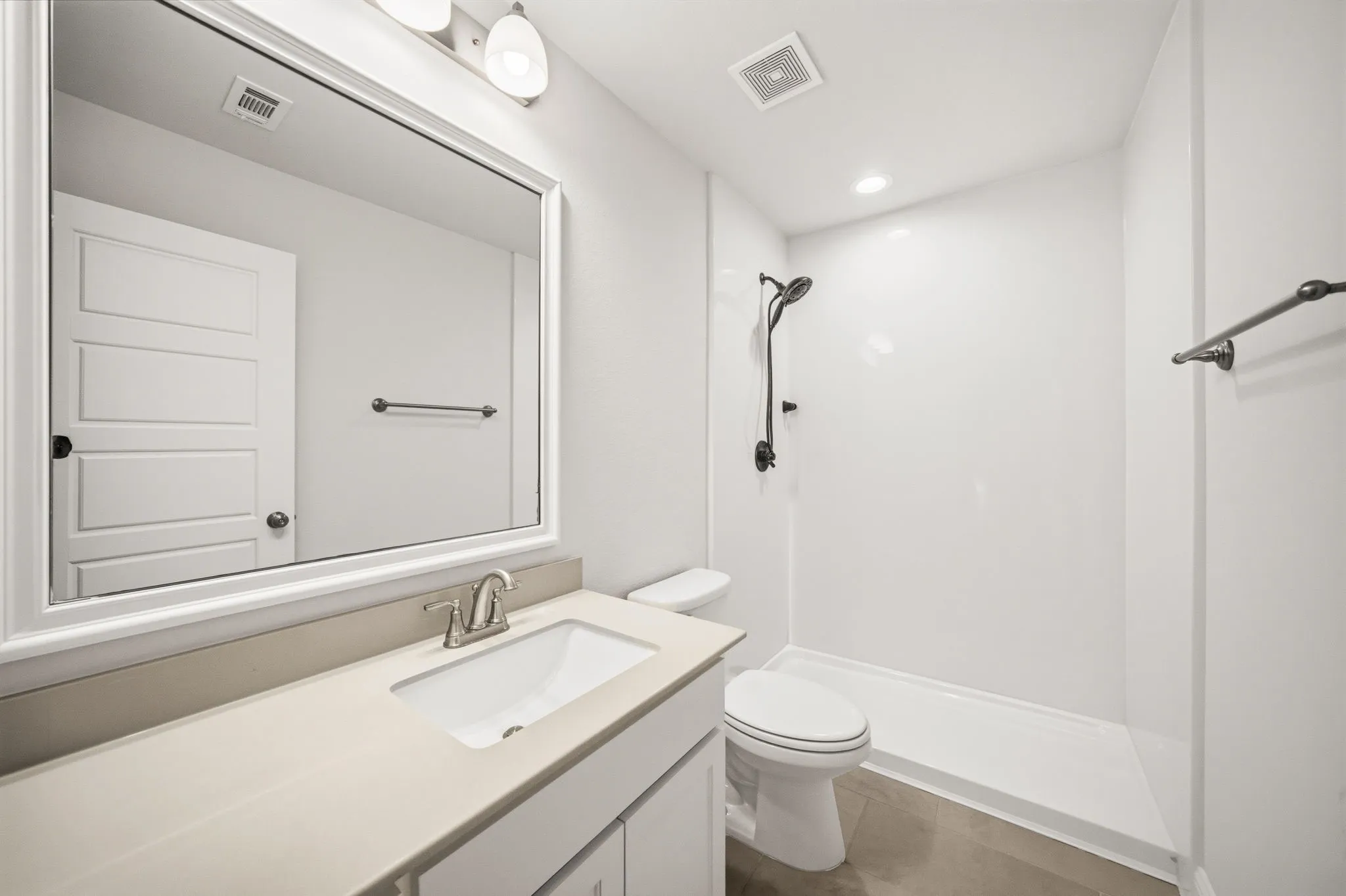 Upstairs bathroom featuring a single vanity with stone-finish countertop, under-mount sink, and brushed nickel faucet
