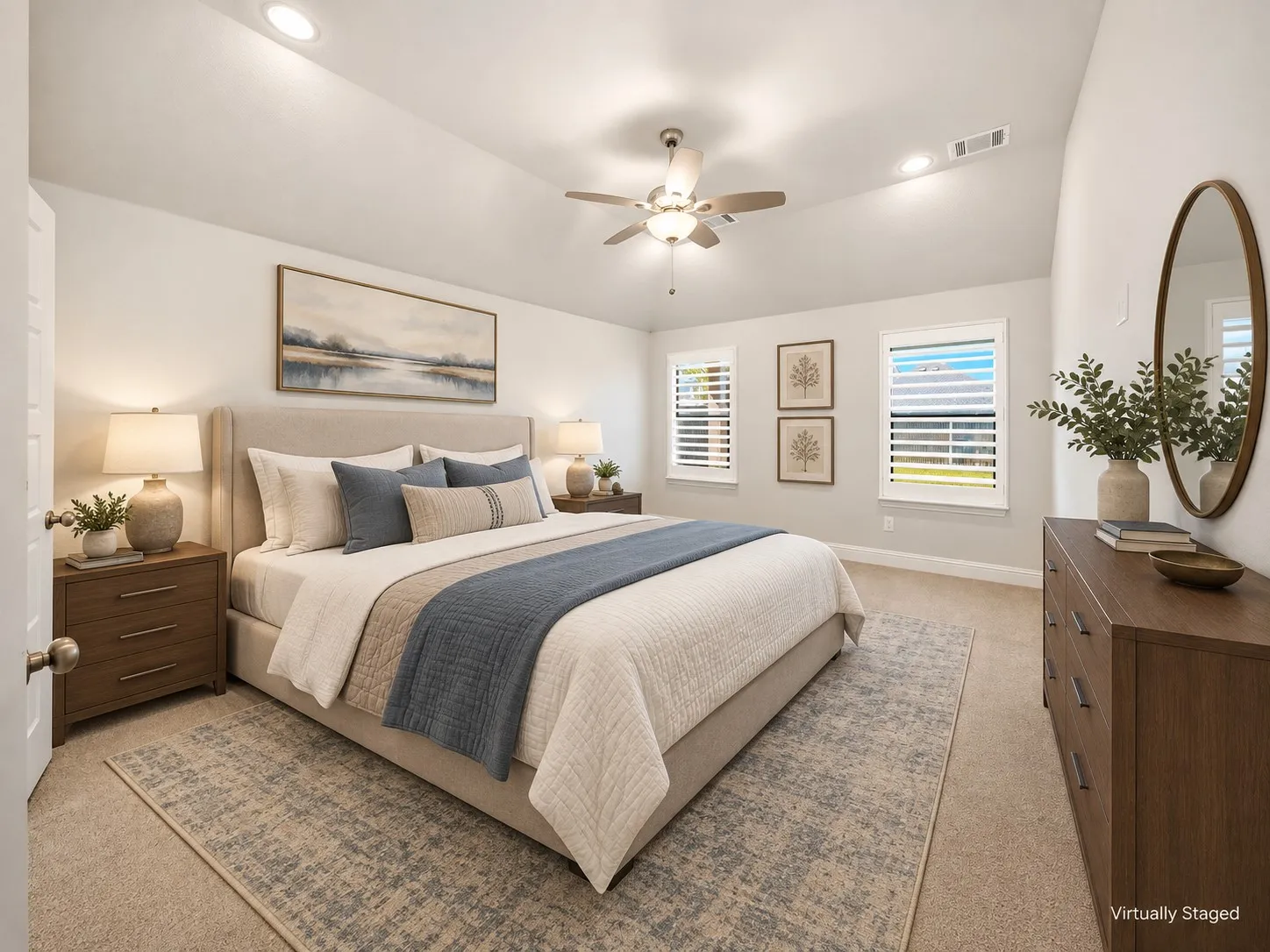 Spacious room featuring vaulted ceilings, recessed lighting, neutral carpet, two windows with blinds, and a ceiling fan with integrated lighting