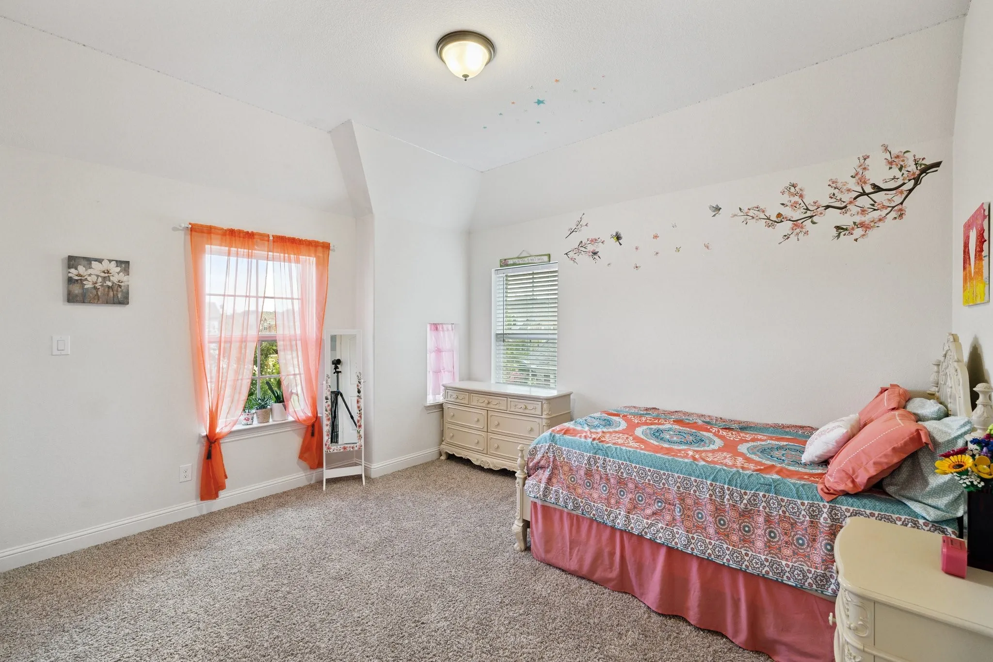 Carpeted room with a vaulted ceiling, recessed window, and white trim