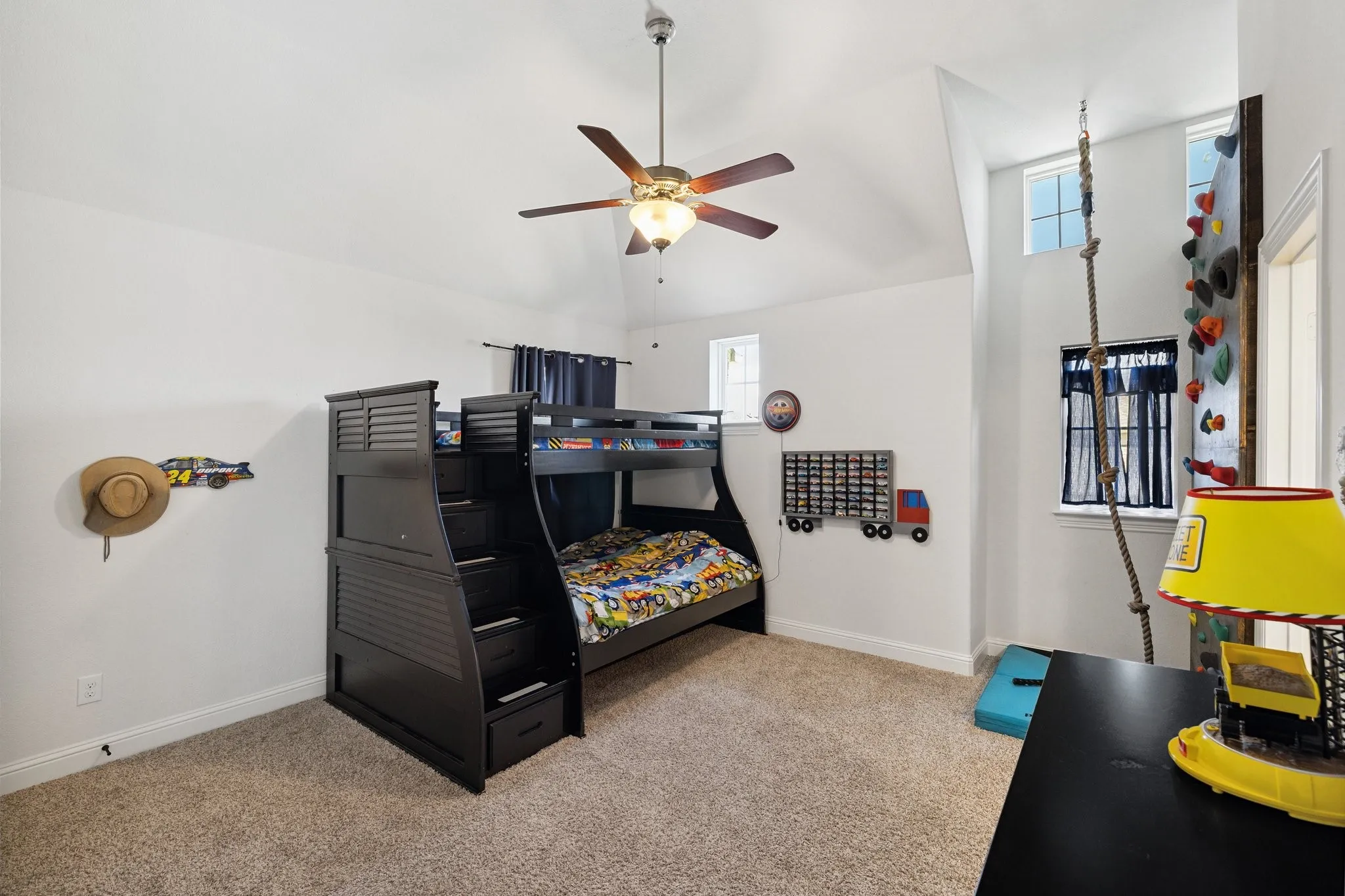 Room with vaulted ceiling, ceiling fan, and carpeted flooring