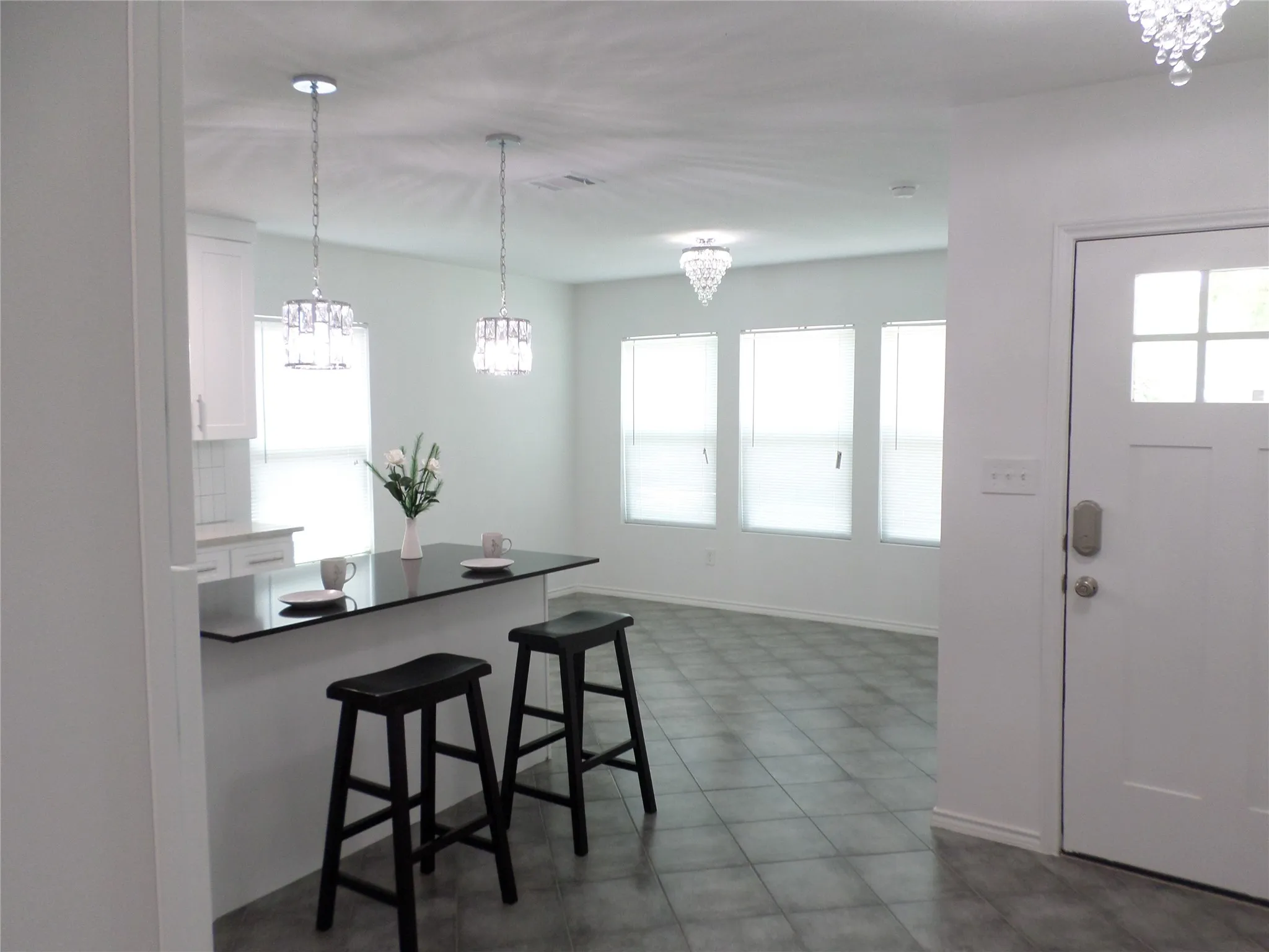 Kitchen island with a dark countertop and two pendant lights