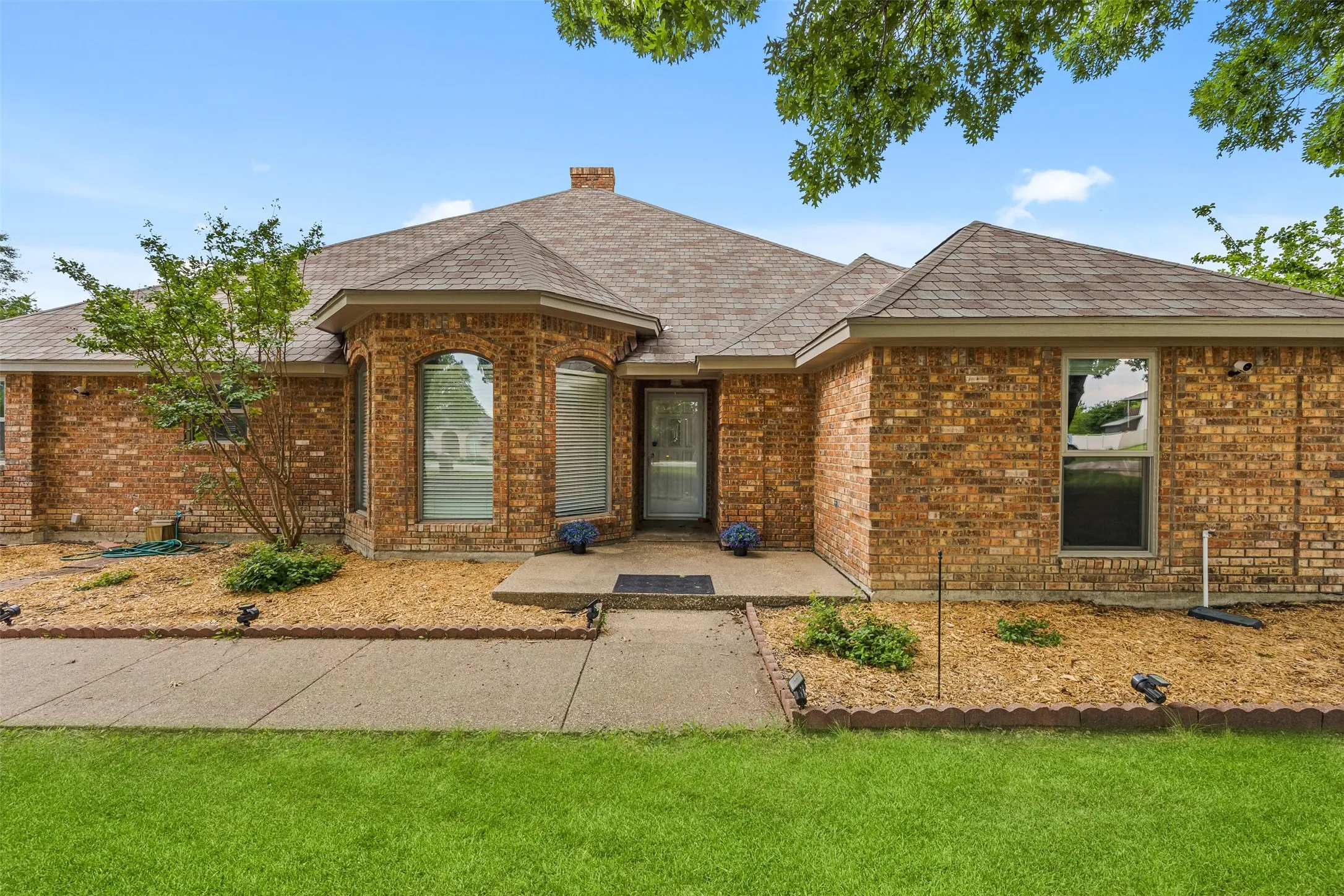 Brick exterior with a prominent bay window feature