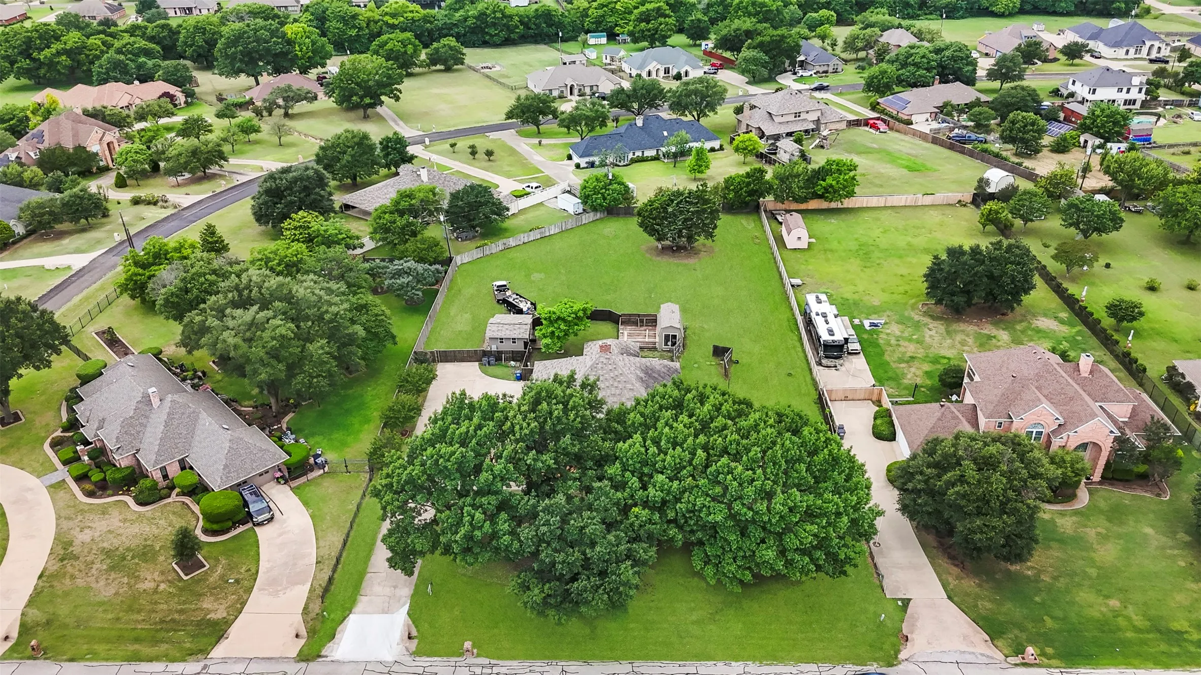 Expansive property featuring a large green lawn and mature trees