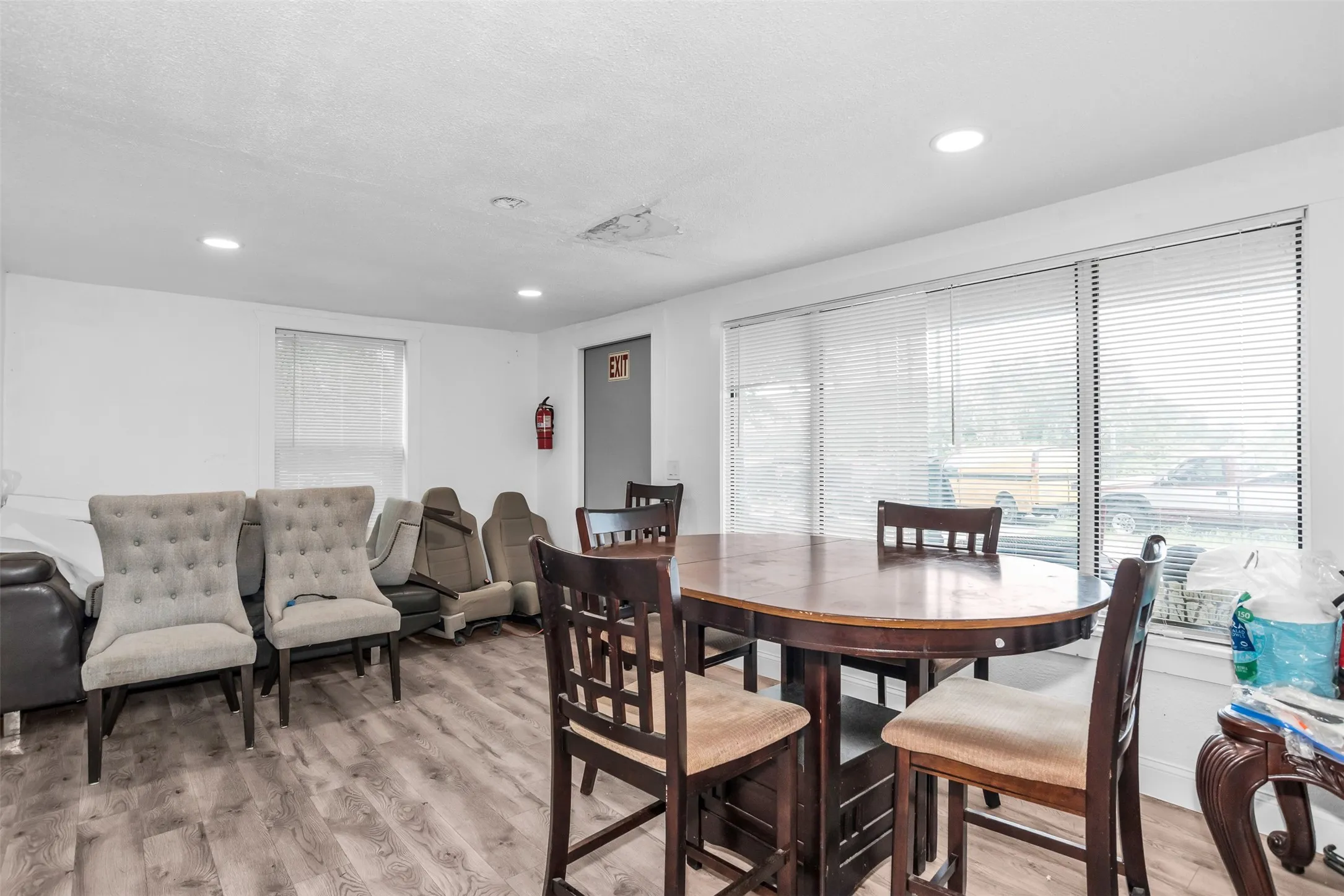 Spacious interior featuring wood-finish flooring, recessed lighting, and white walls