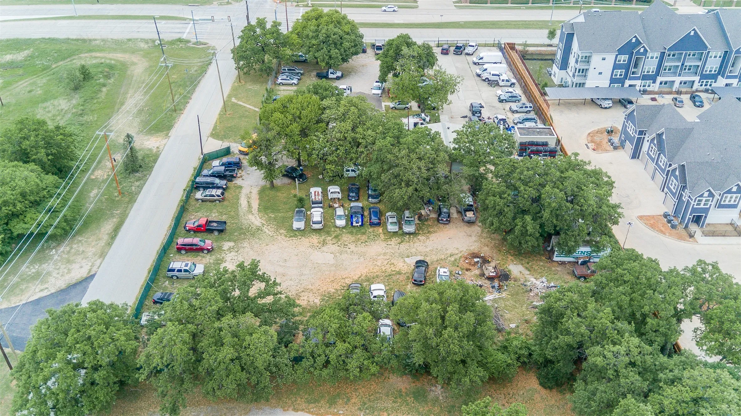 Expansive lot featuring mature trees and a gravel surface