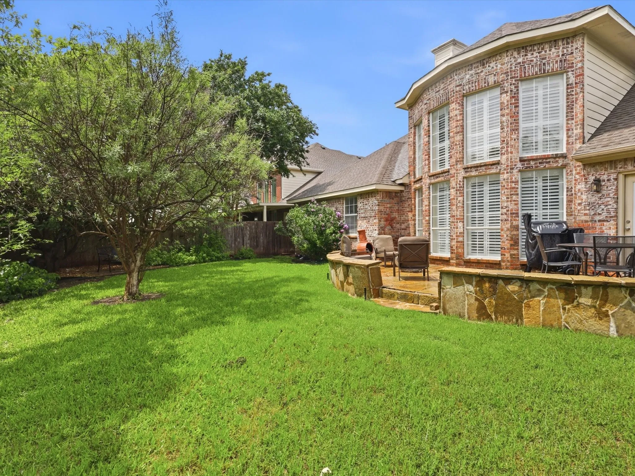Lovely yard with a stone patio.