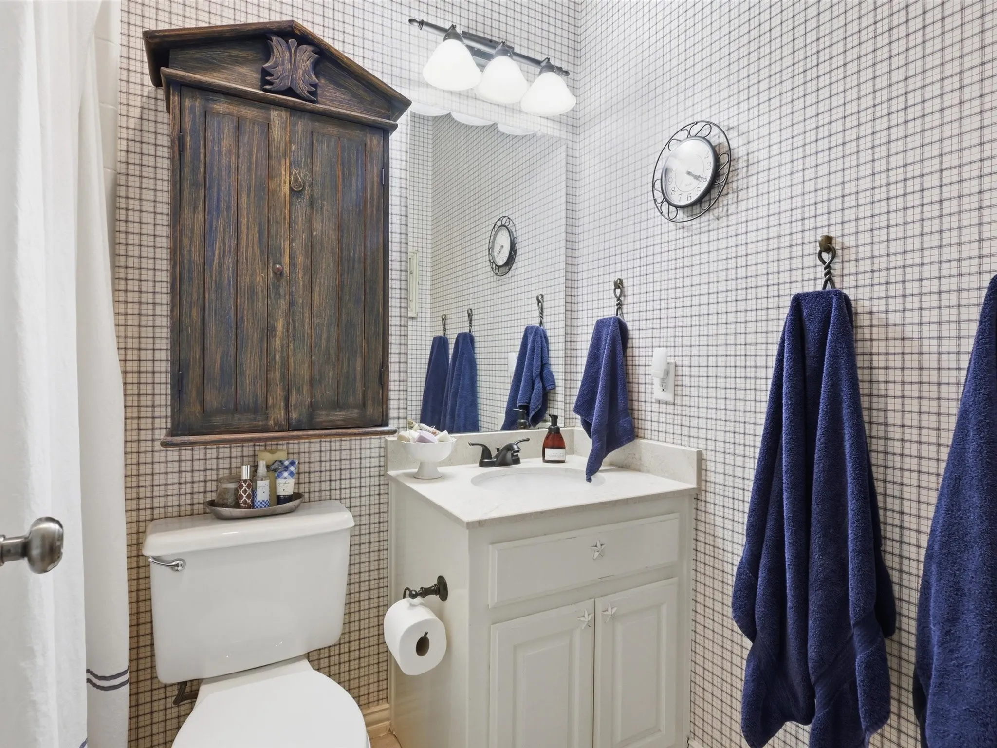 Bathroom directly across from both downstairs bedrooms, separated from the primary suite.