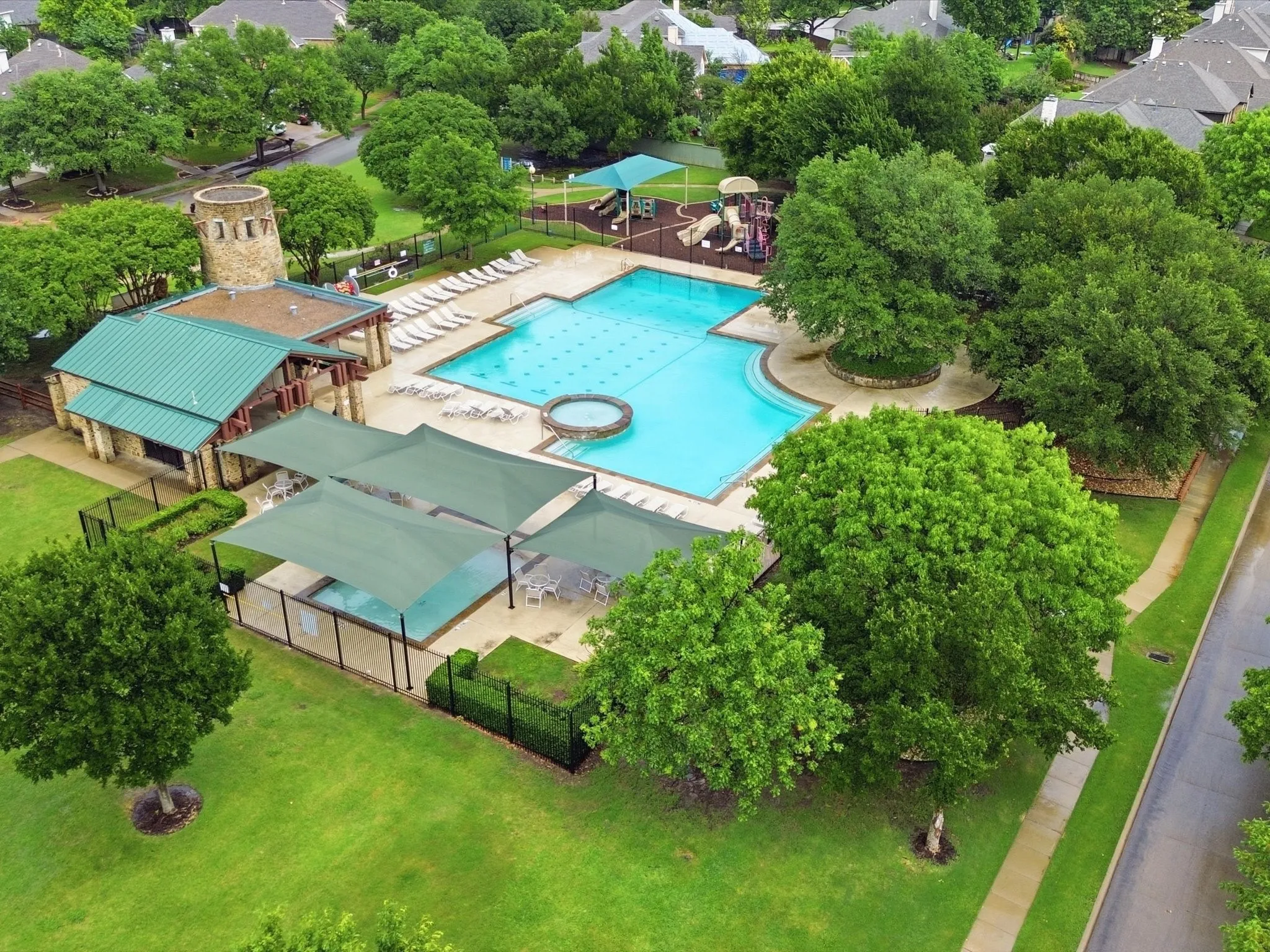 Amenity center located near the home with a large pool and playground.