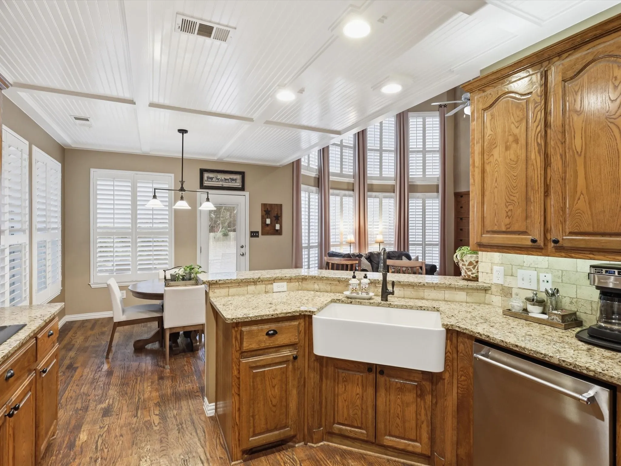Another view of the kitchen featuring coffered beadboard ceilings.