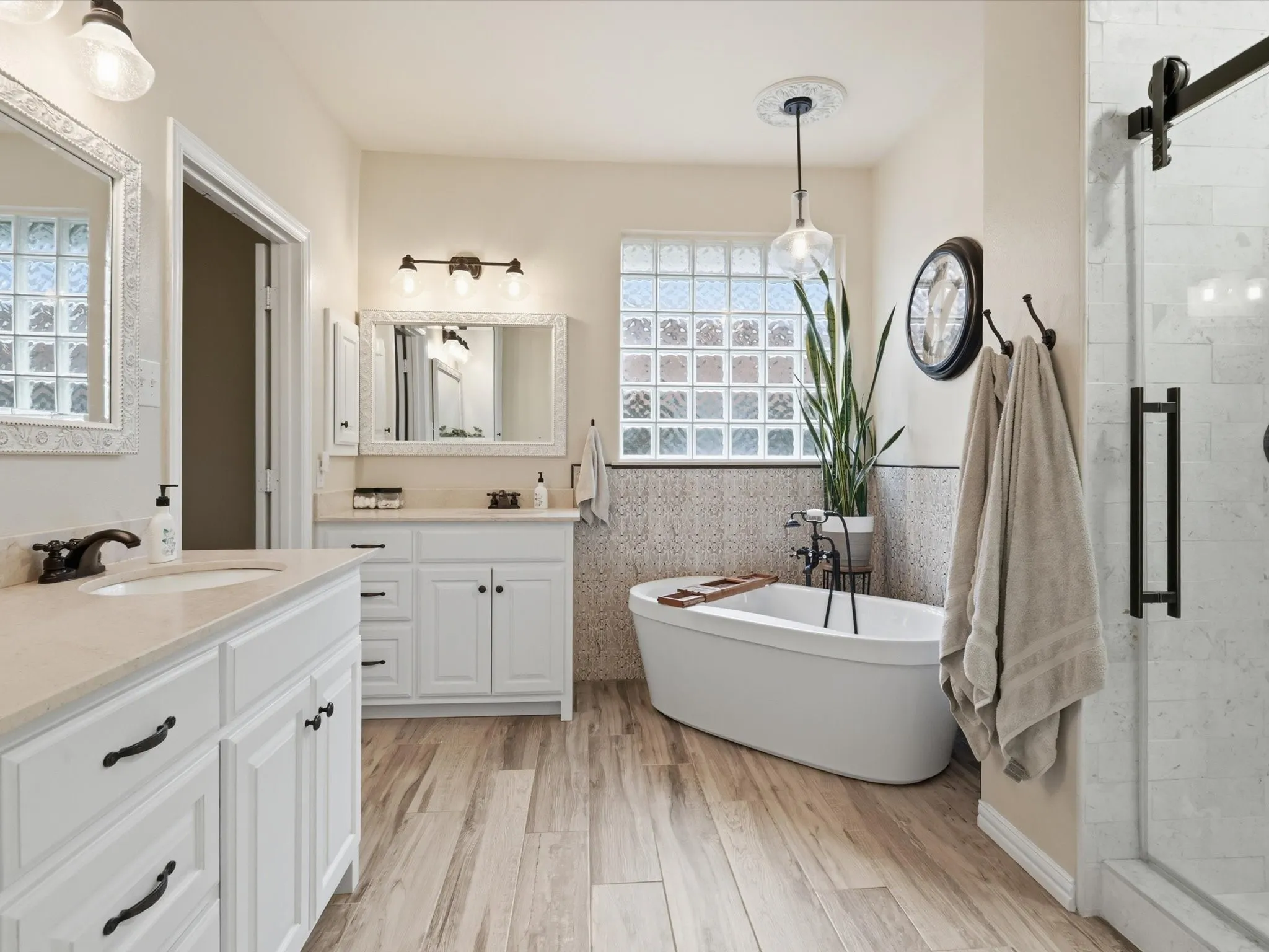 Start your day in style with stone accents and wood-look tile with tons of natural light.