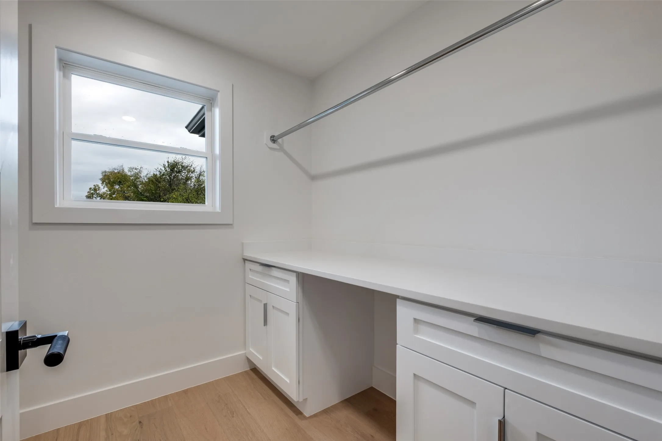 Upstairs laundry room with sink, storage and drip dry hanging