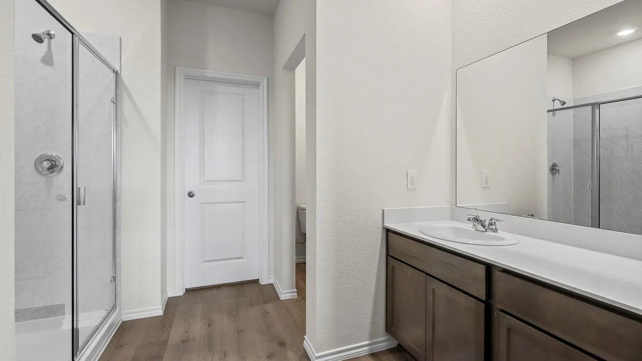 Modern bathroom featuring a glass-enclosed shower with chrome fixtures