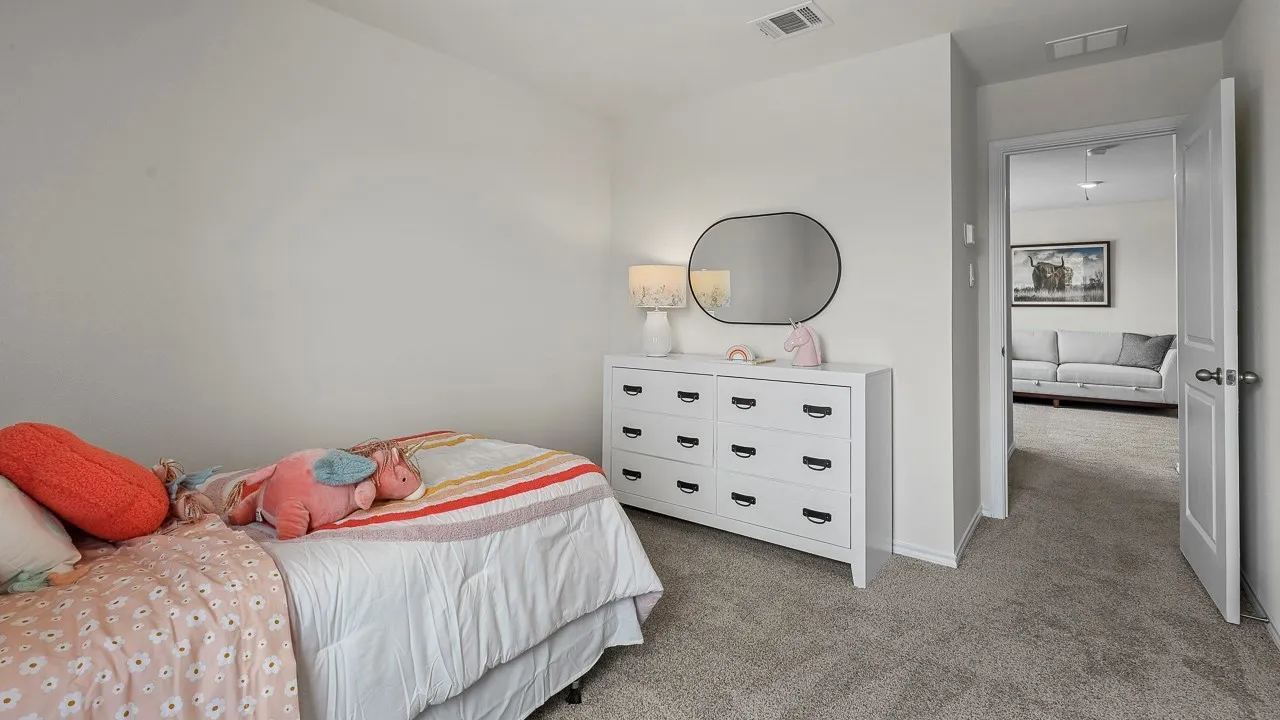 Carpeted room with light-colored walls and a white door
