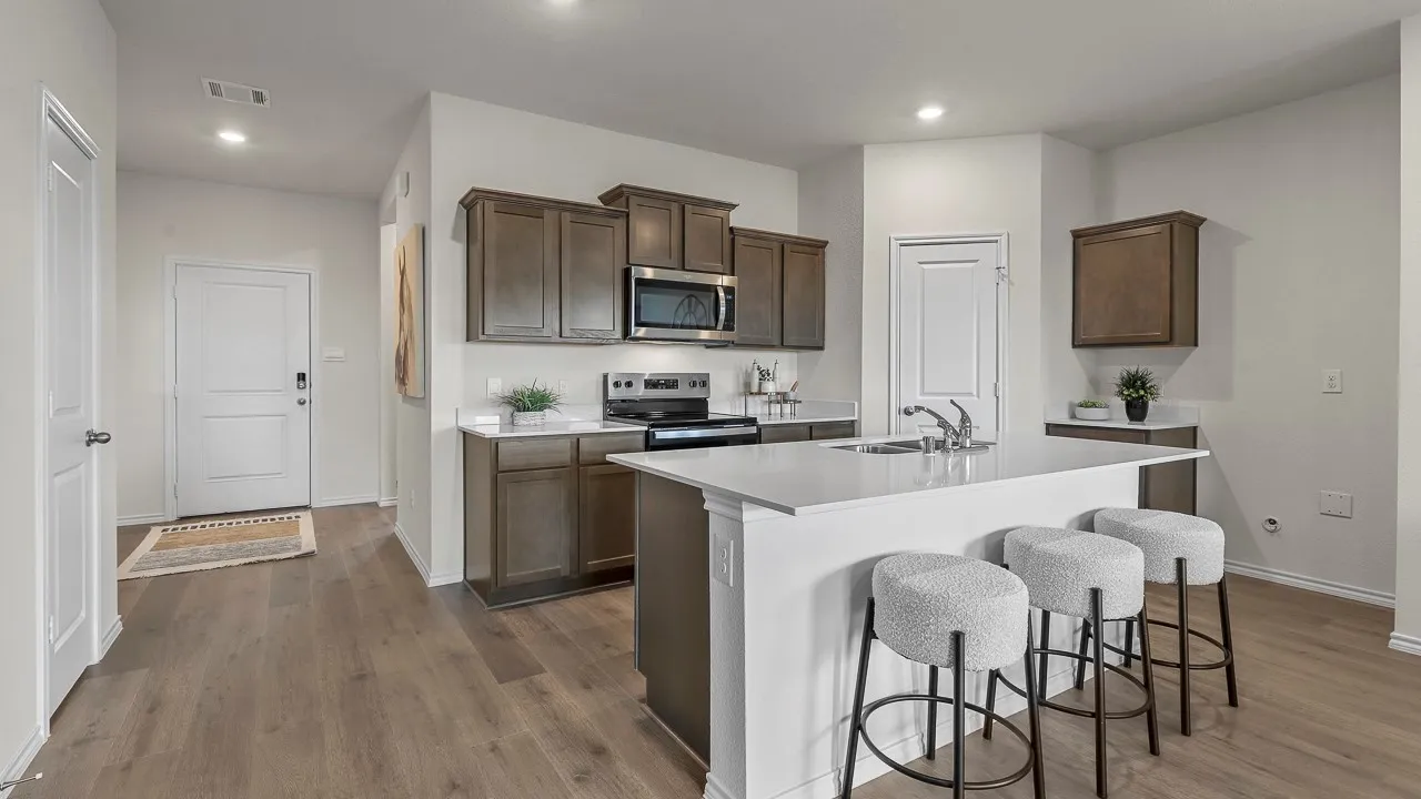 Open-concept kitchen featuring wood-finish flooring, recessed lighting, and white walls
