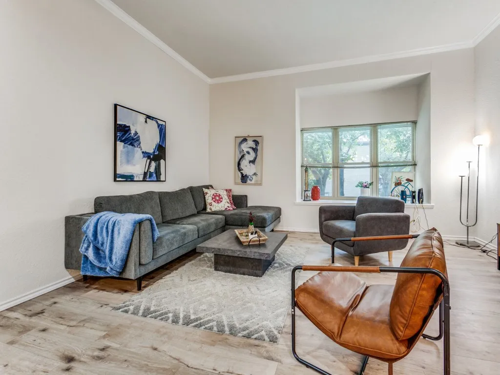 Living area featuring ornamental molding and wood finished floors