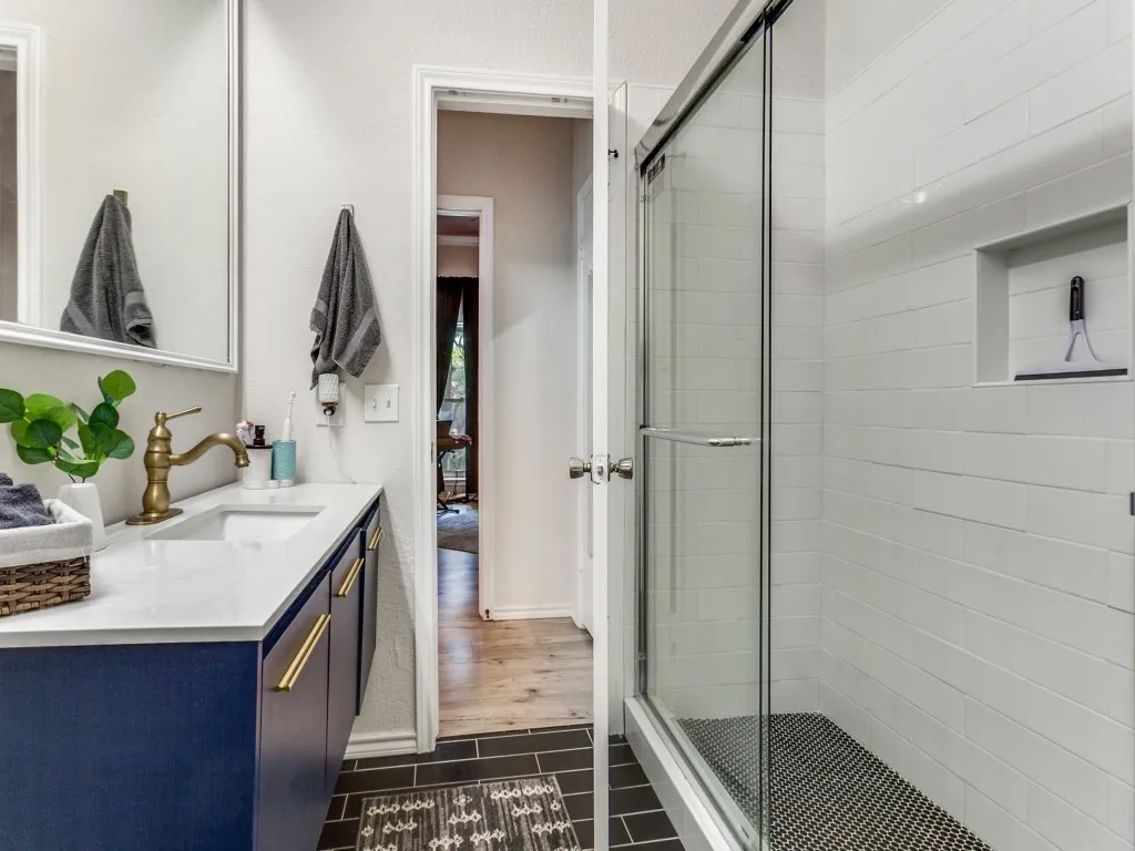 Full bath with vanity and a stall shower