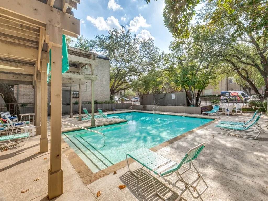 Community pool featuring a patio and a pergola