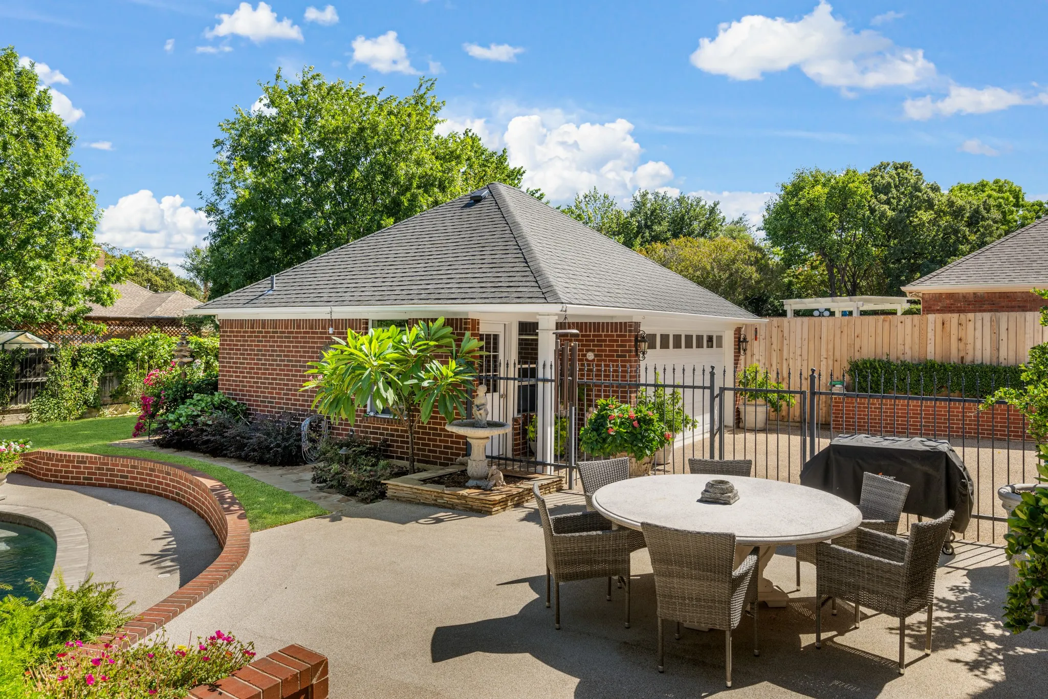 The detached 2-car garage has a half bath for swimmers.