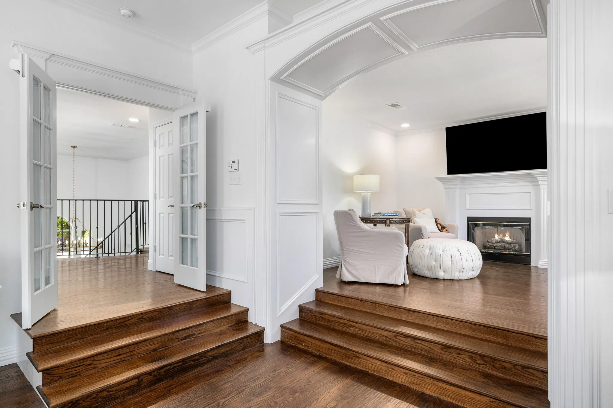 Enter through a arched entry way into the sitting room adjacent to the master bedroom.
