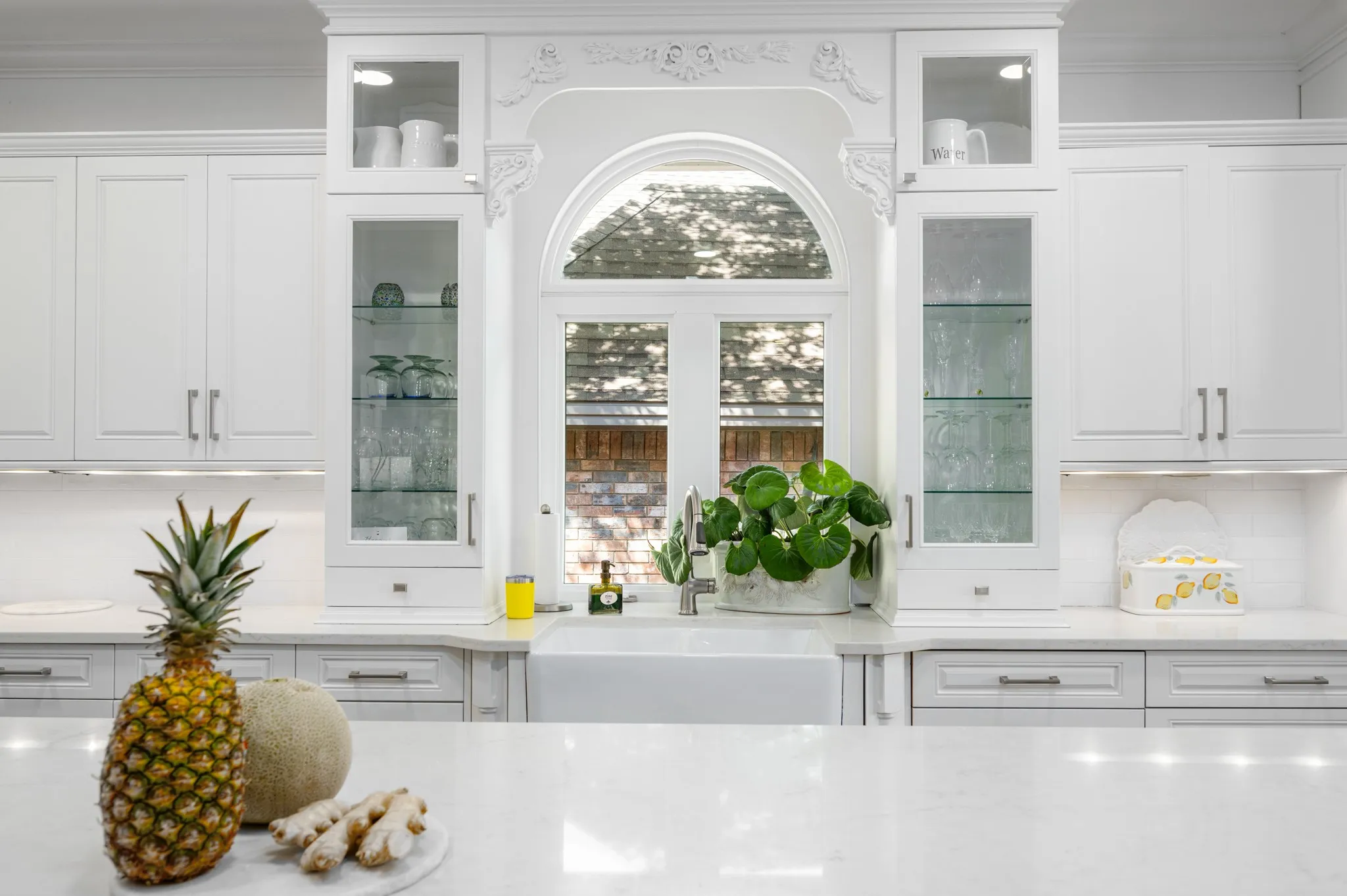 The classic wood applications framing the window and sink area add artful touches.