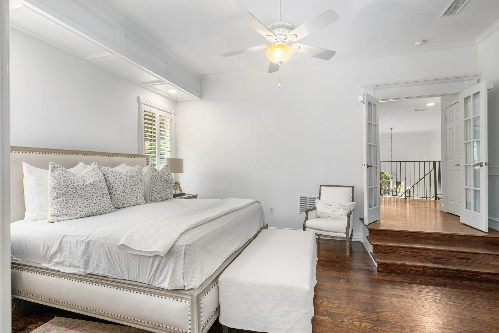 Enter the primary suite through pretty French doors.