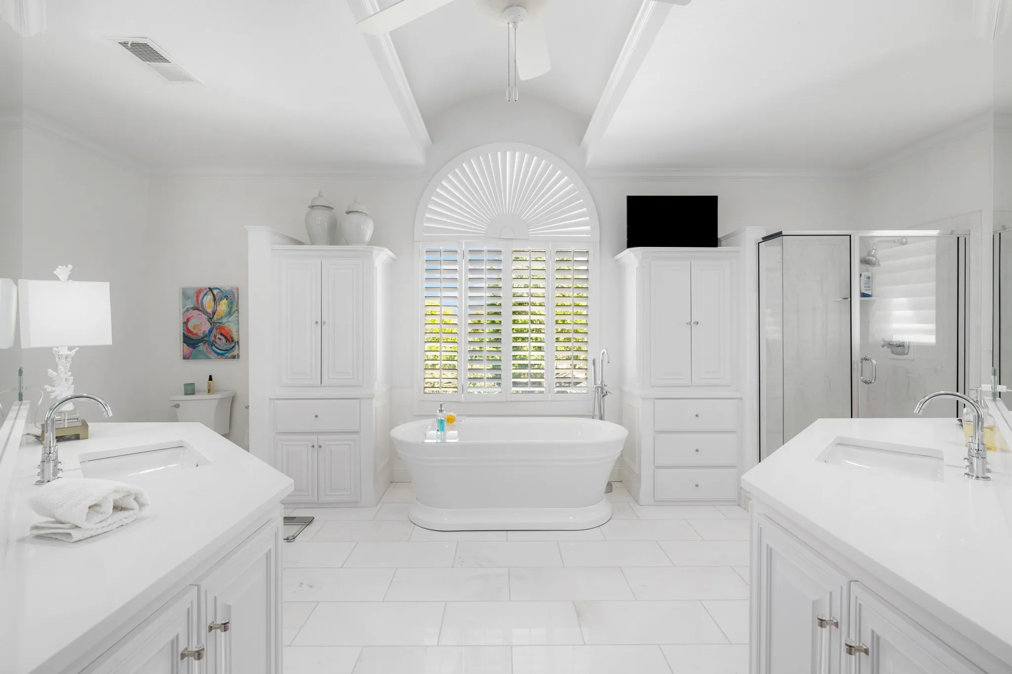 A barrel vaulted ceiling in the primary bath.