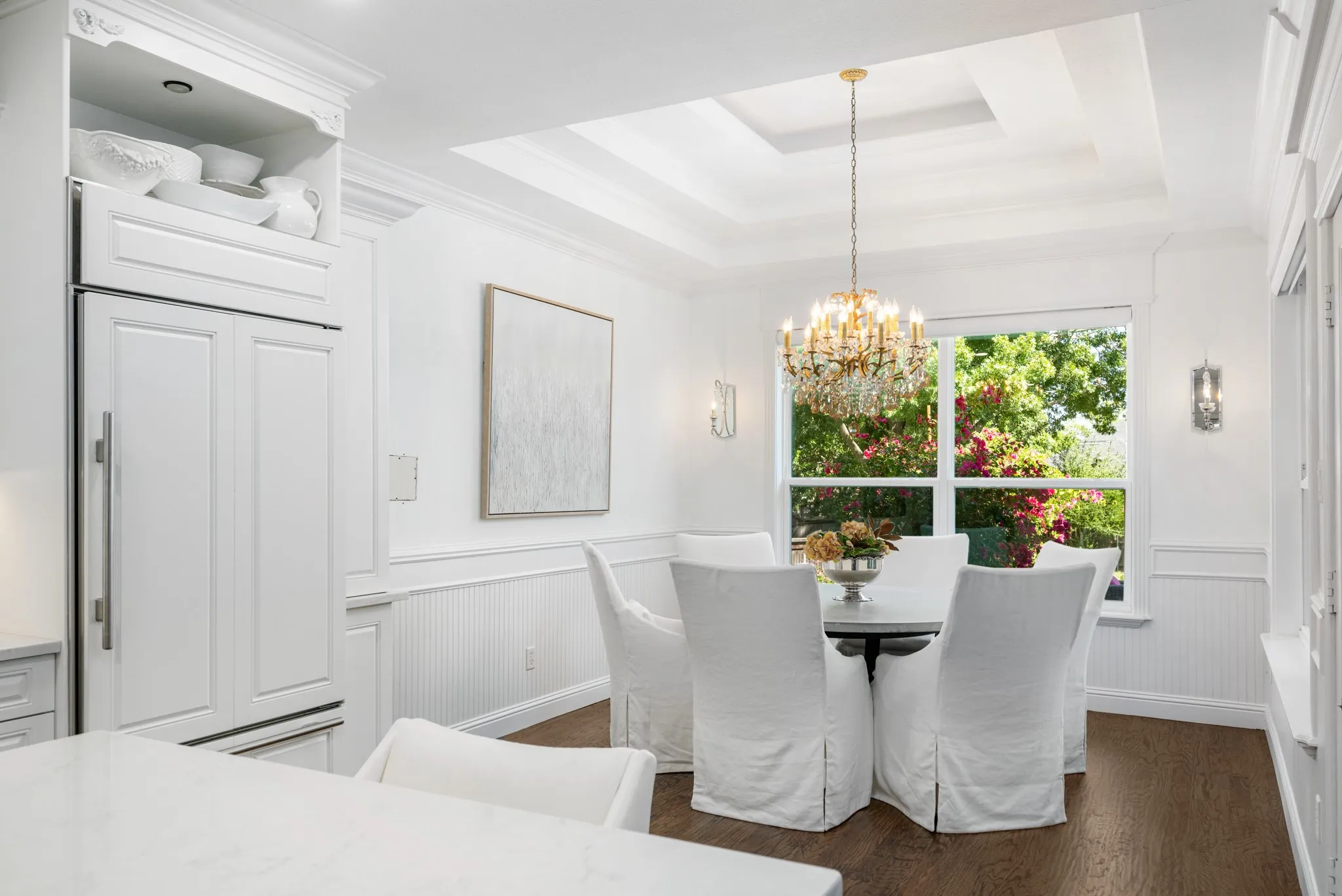 The lighted tiered tray ceiling showcases the breakfast area and the mirrored sconces add a touch of elegance.