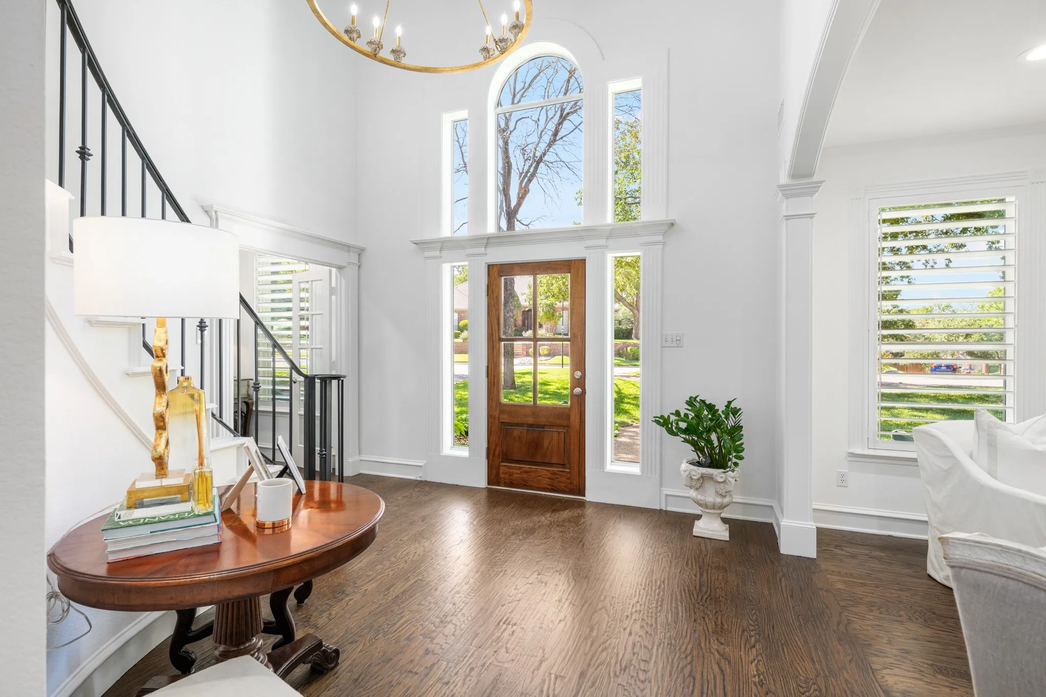 A soaring ceiling and exquisite Aiden Gray light fixture welcomes you home!