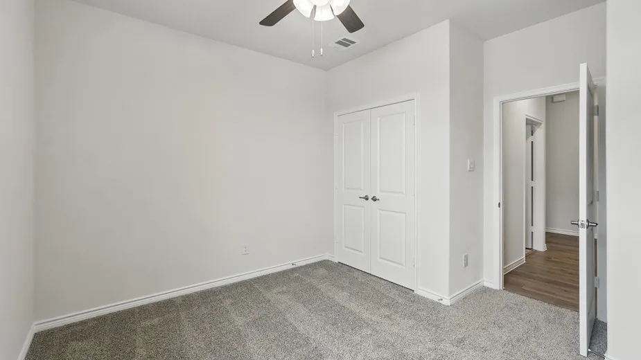 Neutral tone walls and grey carpet flooring