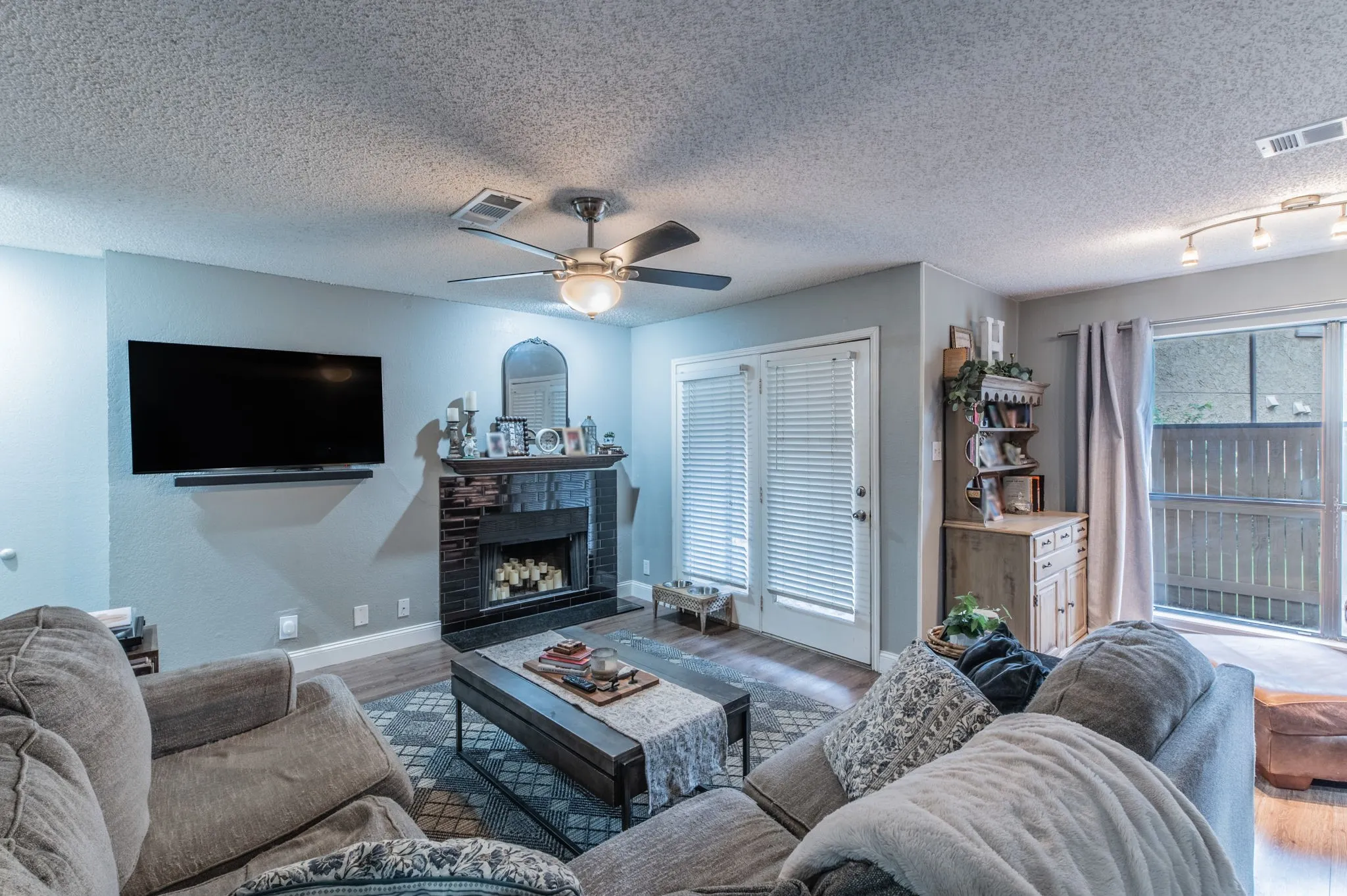 Neutral colors and a tile fireplace add a custom touch to the spacious living area.