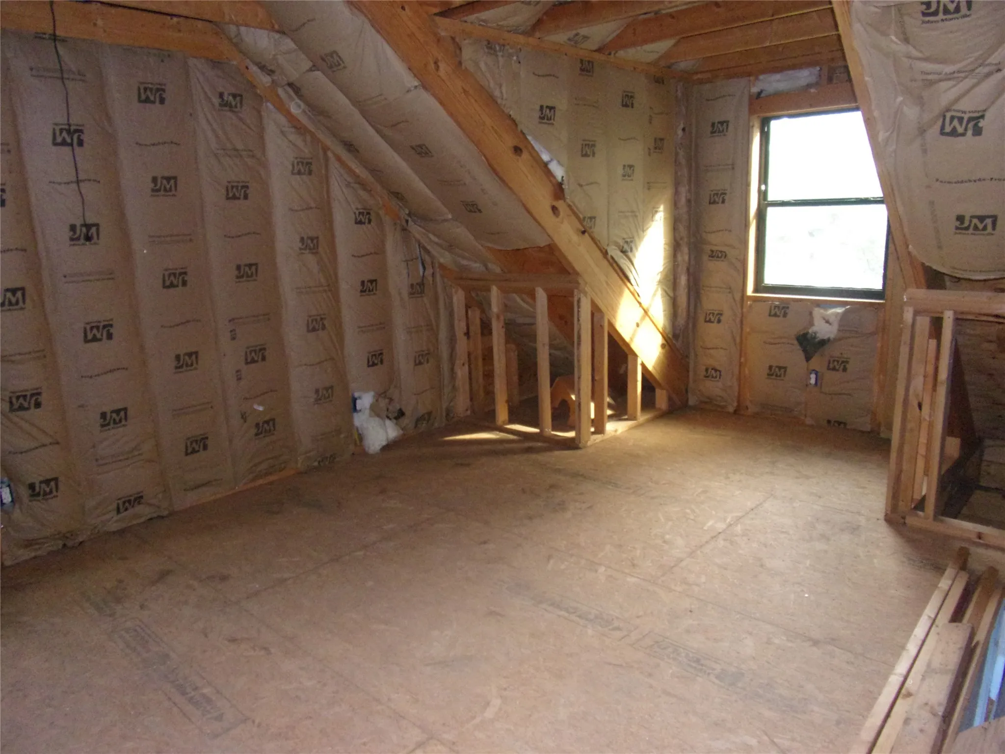 unfinished upstairs bedroom with water view