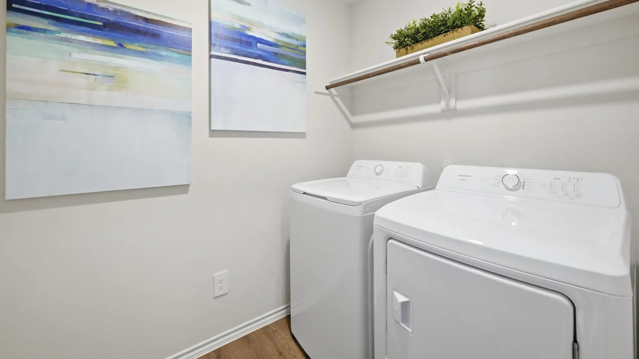 Dedicated laundry space featuring a white top-load washing machine and white front-load dryer