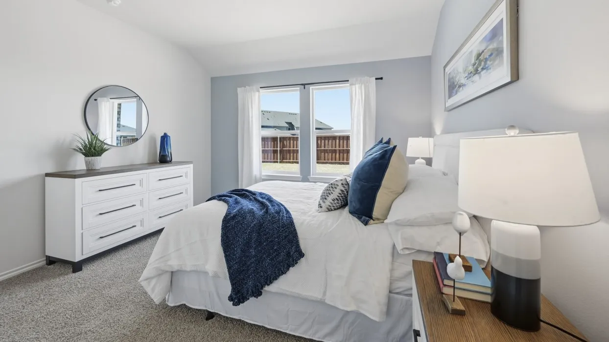 Carpeted bedroom featuring a vaulted ceiling and a light blue accent wall