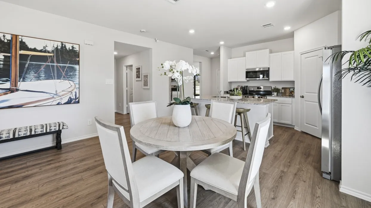 Open-concept living space featuring wood-finish flooring, recessed lighting, and a neutral color palette
