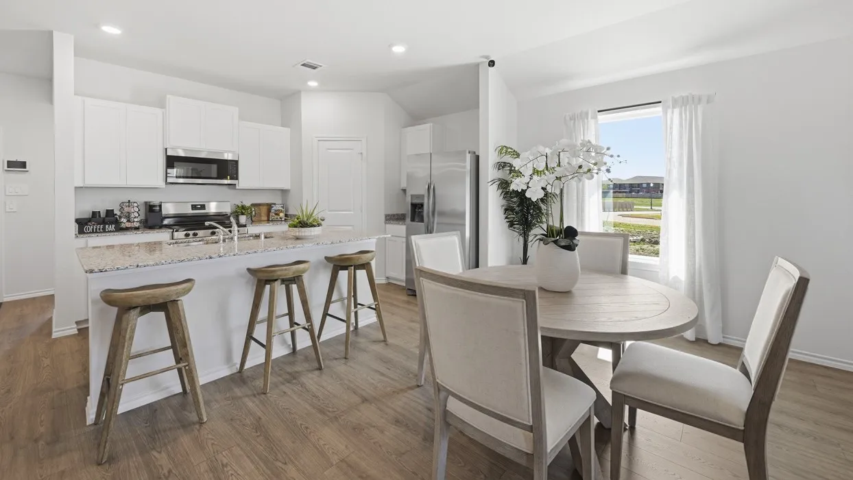 Open-concept kitchen and dining area with wood-finish flooring