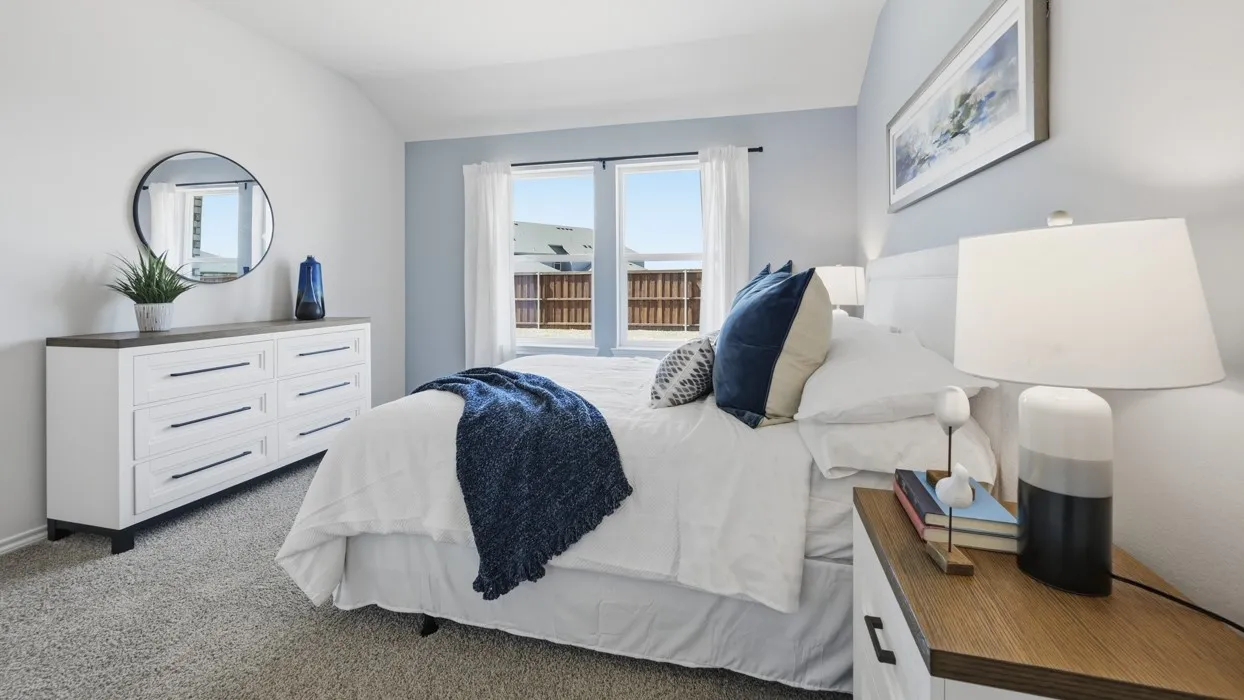 Bedroom featuring soft grey wall-to-wall carpeting and neutral wall paint with a contrasting accent wall