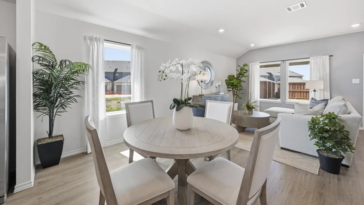 Open-concept living space with wood-finish flooring, recessed lighting, and vaulted ceilings