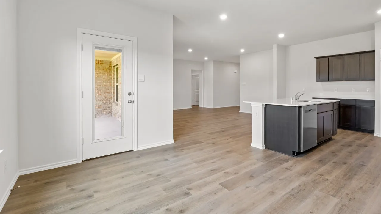 Open concept living space featuring wood-finish flooring, recessed lighting, and a modern kitchen island with an integrated stainless steel dishwasher