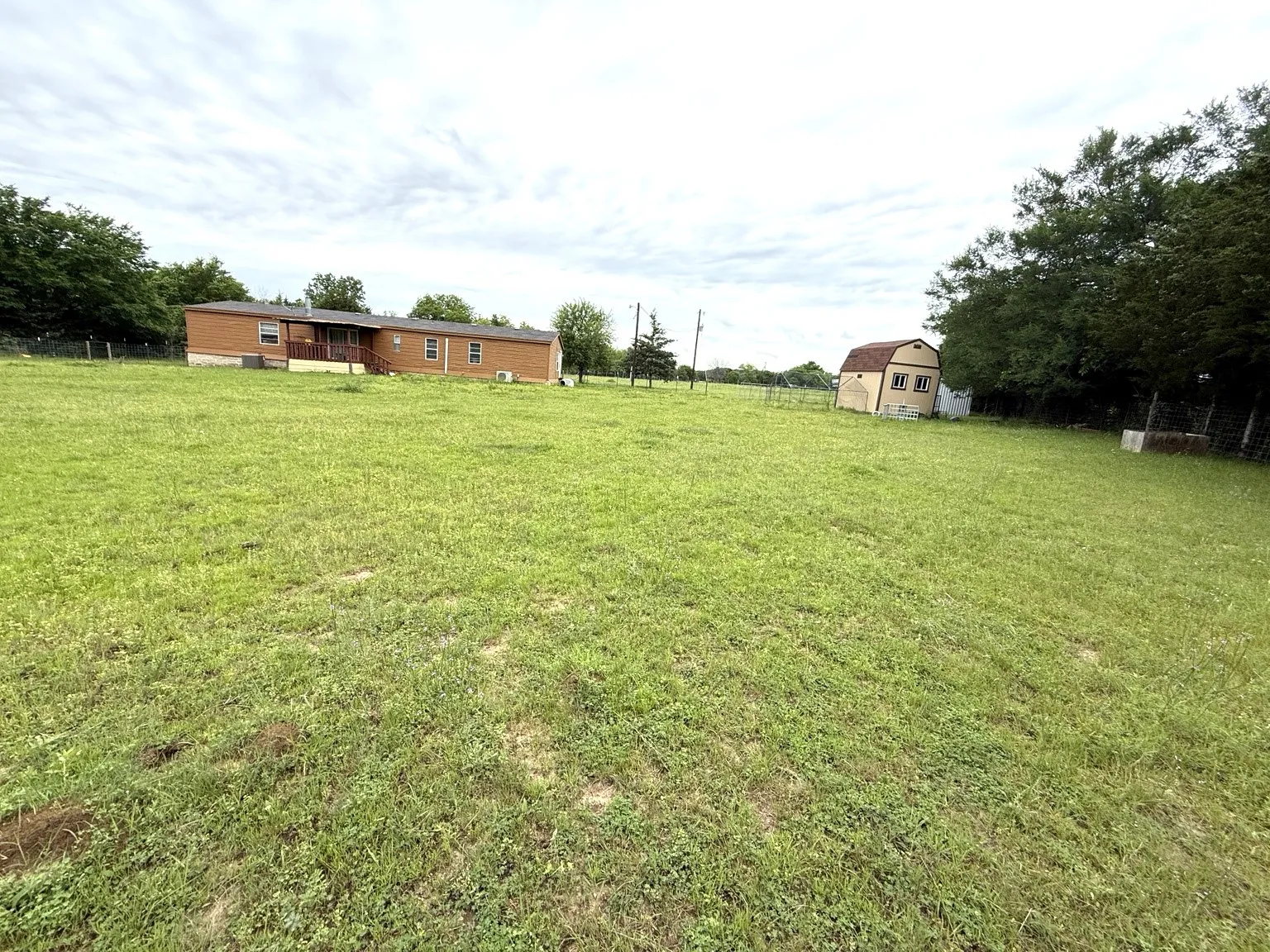 Back of home with complete fenced area.