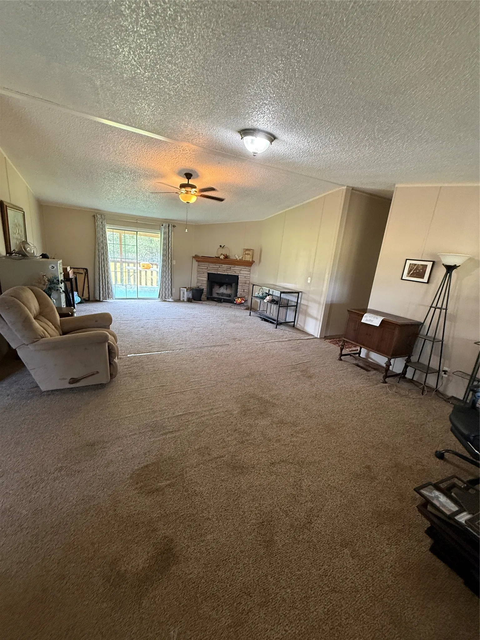 Living room with fireplace has access to the back porch.