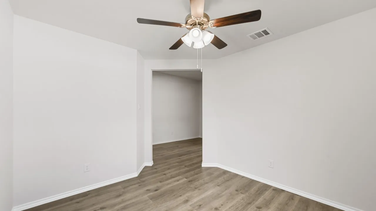 Interior room with light gray walls and wood-finish flooring