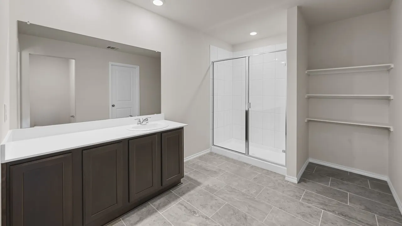 Bathroom featuring a spacious vanity with dark wood-finish cabinetry, a white countertop, and an integrated sink