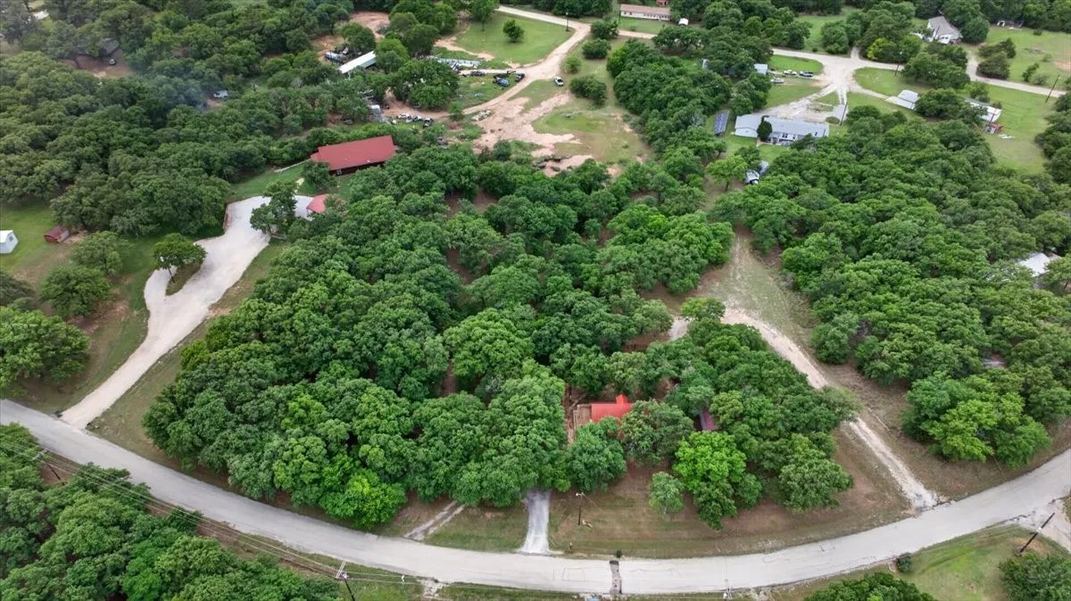 Beautifully treed lot located in a gentle curve with 2 driveway entrances for additional parking.
