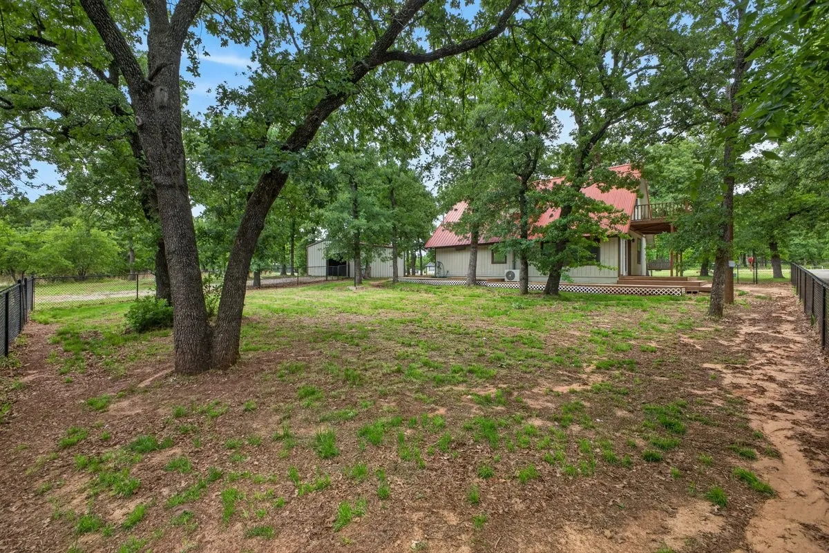 Looking from the farthest corner of fenced yard toward the home

