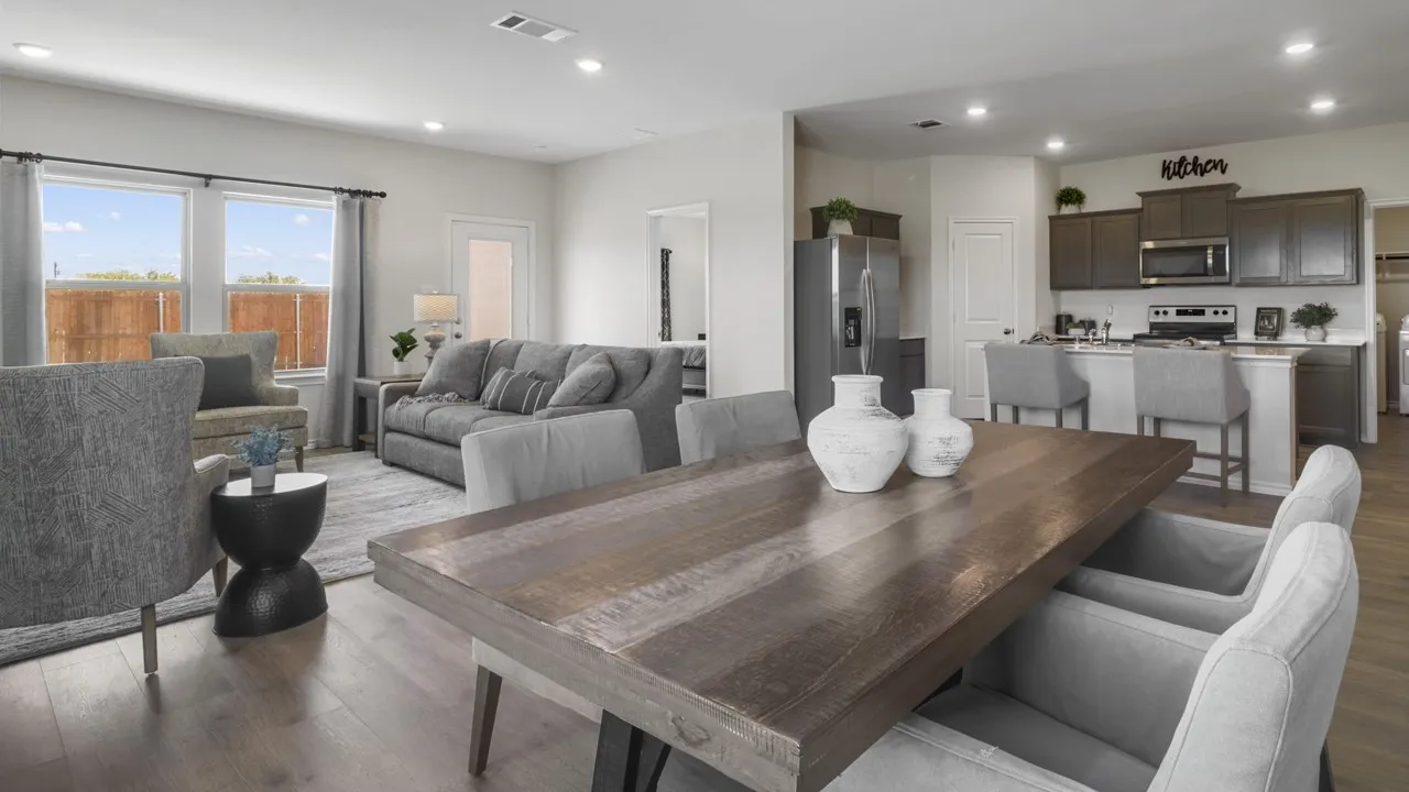 Open-concept living space featuring wood-finish flooring, recessed lighting, and a kitchen with dark cabinetry